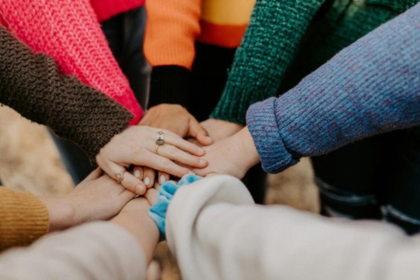 group of friends keeping hands together