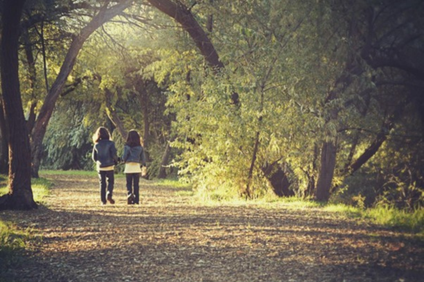 girls walking in the woods